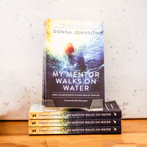 My Mentor Walks on Water books stacked up.